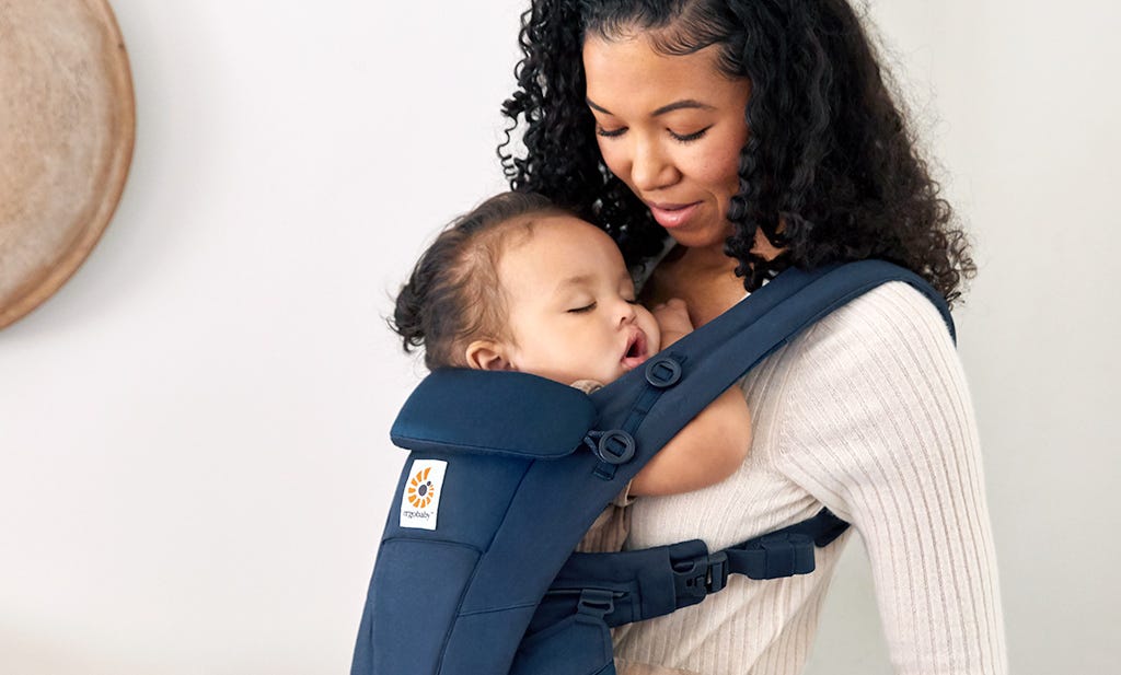 Baby having nap sleep in a carrier