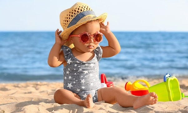 Baby playing on the beach,Summer baby essentials 